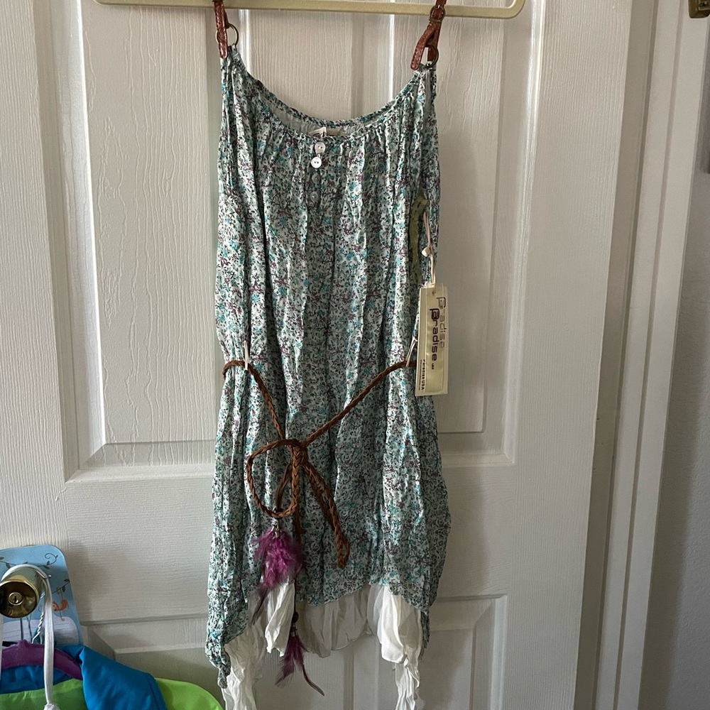 Great tunic with leather like straps and waist belt.